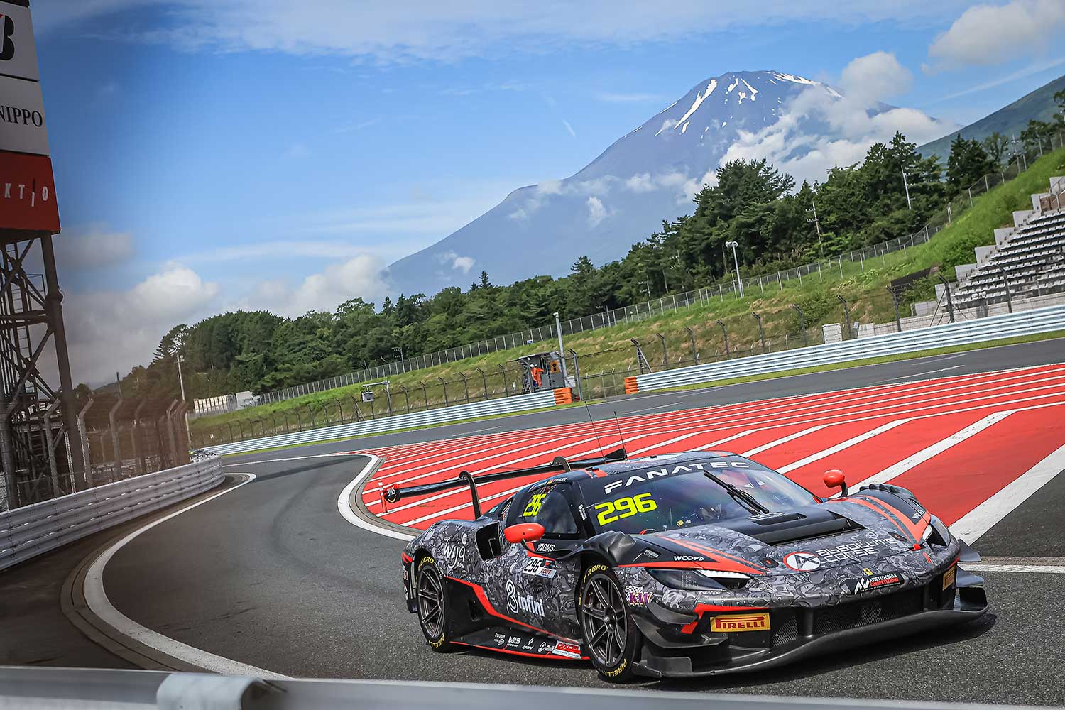 The Absolute Racing Ferrari 296 GT3 on the circuit at Fuji Speedway, Mount Fuji rising behind